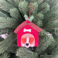 Christmas Jack Russell in kennel decoration hanging on a green Christmas tree.
