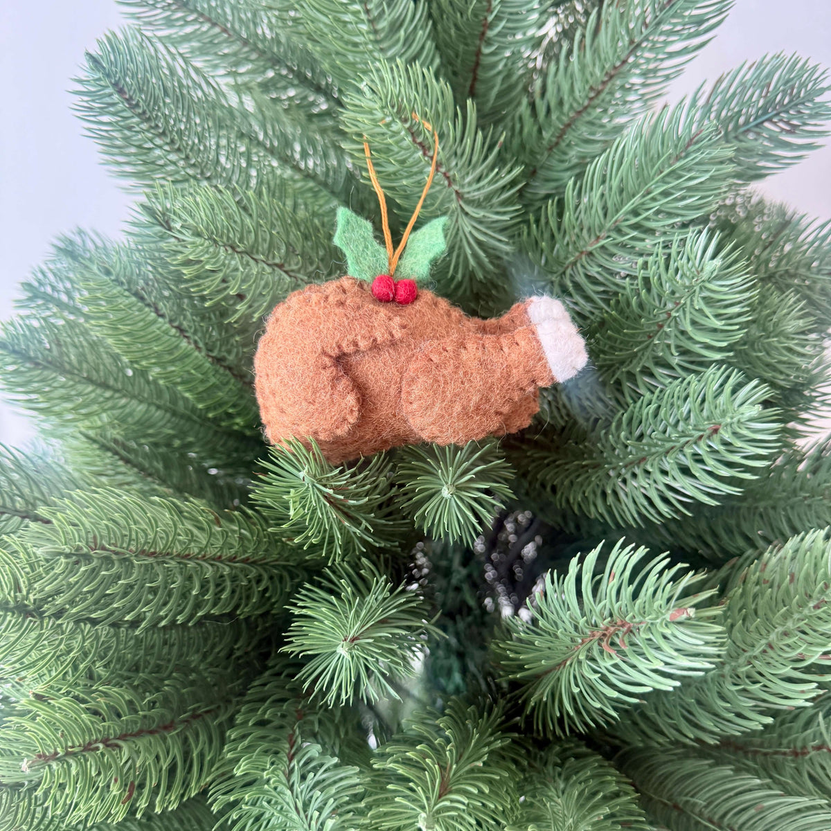 Christmas Roast Turkey decoration made of felt, featuring holly, hanging on a Christmas tree