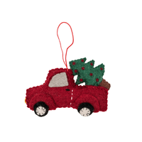Red Christmas truck decoration carrying a Christmas tree, perfect for festive holiday decor.