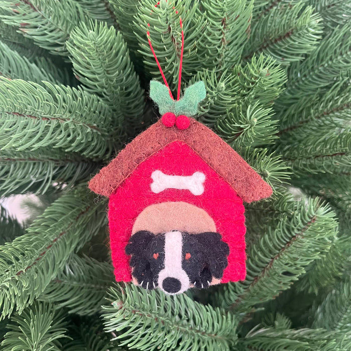 Christmas Collie in Kennel Decoration hanging from a Christmas tree adorned with festive greenery.
