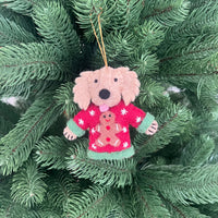 Dogs in Christmas sweater decorations - cute dog ornament on a Christmas tree, adding festive cheer.