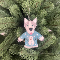 Dogs in Christmas sweater decorations hanging on a tree, featuring a cute dog in a snowman sweater.