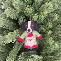Dogs in Christmas sweater decorations hanging ornament on a Christmas tree.