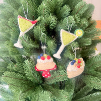 Christmas Pavlova decorations featuring colorful handmade felt ornaments on a festive tree.