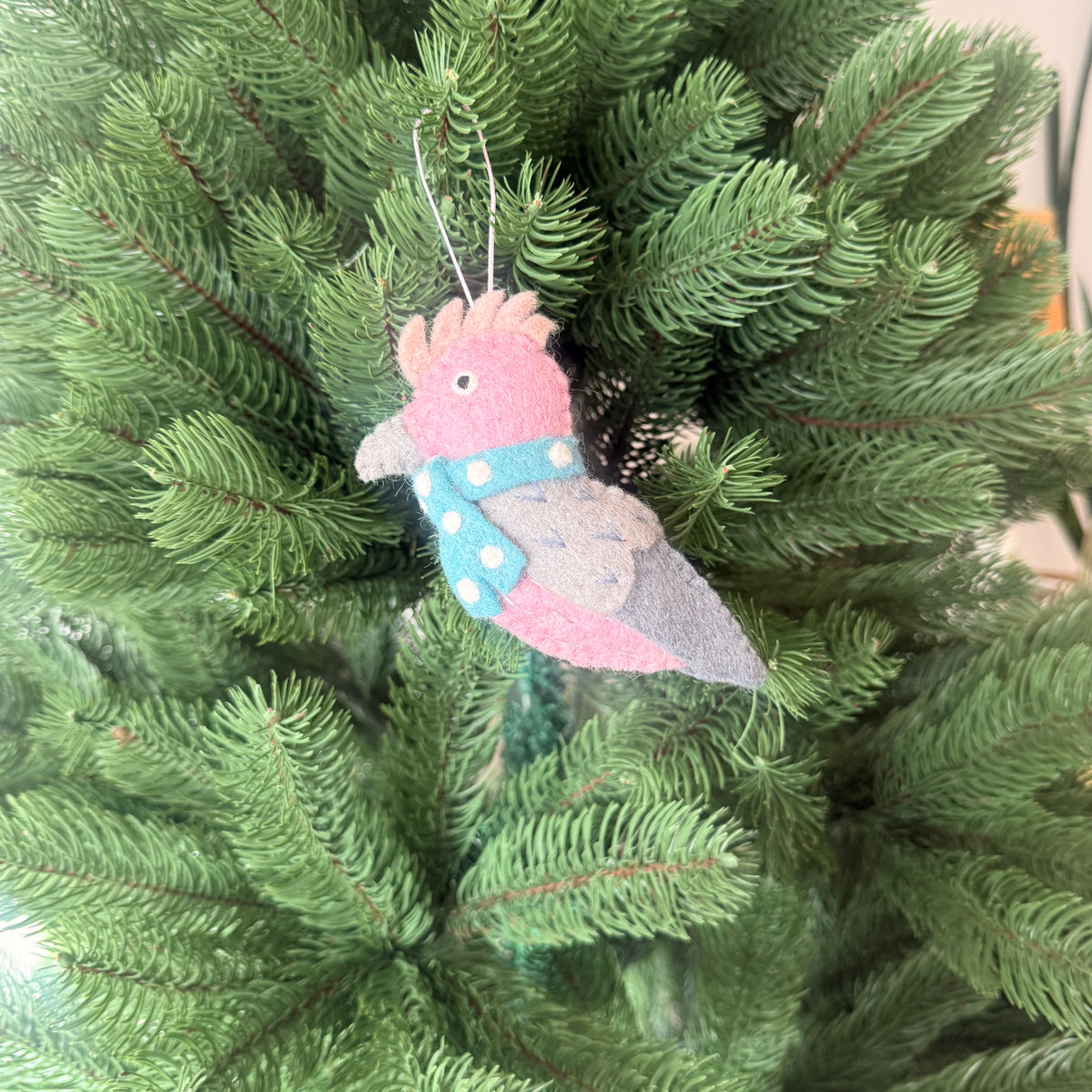 Pink Galah Christmas Decoration hanging on a Christmas tree, colorful and festive ornament.