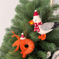 Christmas prawns and lobster decorations on a Christmas tree with festive ornaments.