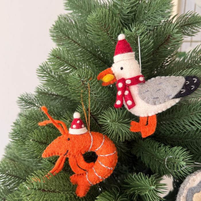 Christmas prawns and lobster decorations on a Christmas tree with festive ornaments.