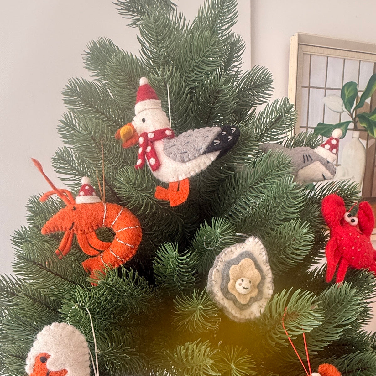 Christmas prawns and lobster decorations on a festive tree with colorful ornaments and sea-themed designs.