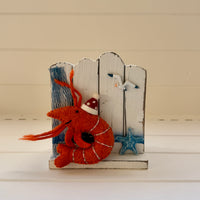 Christmas prawns and lobster decorations featuring a festive red shrimp and starfish on a wooden background
