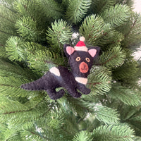 Tasmanian Devil Christmas Decoration hanging on a Christmas tree, featuring a playful design with a festive hat.