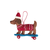 Christmas Dachshund on skateboard ornament featuring a dog in a sweater and hat on a skateboard.