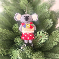 Koala with Aussie Christmas treats decorations hanging from a Christmas tree, featuring colorful felt and a festive design.