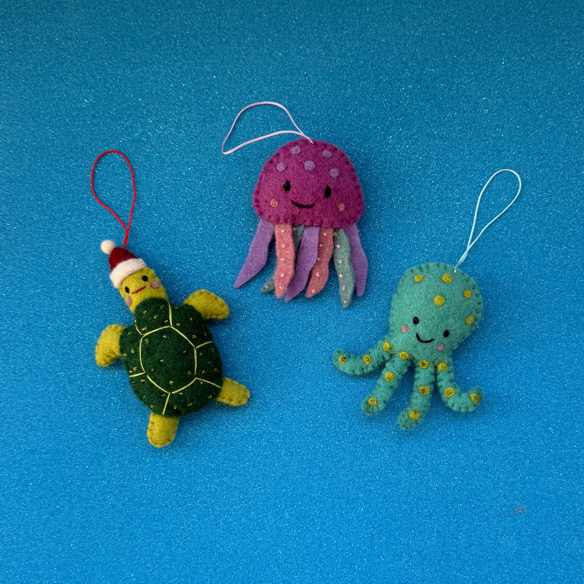 Sea creature Christmas decorations featuring a turtle, jellyfish, and octopus with sparkly beads.
